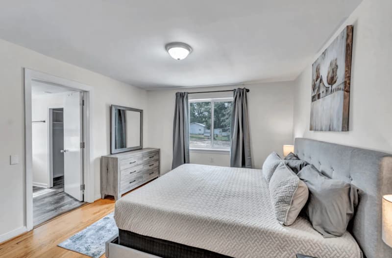A neatly prepared bedroom in a furnished home